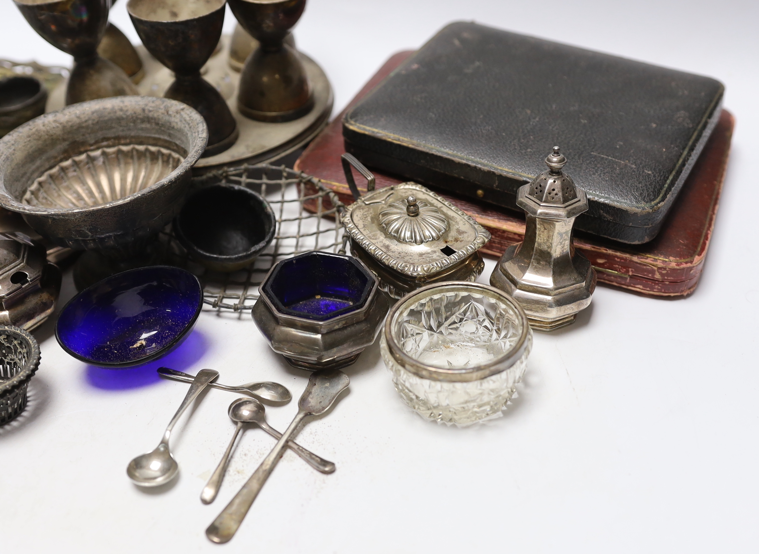 Sundry silver including three piece condiment set, two cased sets of teaspoons, five other condiments, salt spoons, pair of small pierced holders, inkwell and a small rose bowl, together with various plated items.